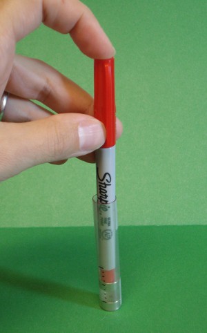 Pen pushing down levitating magnet