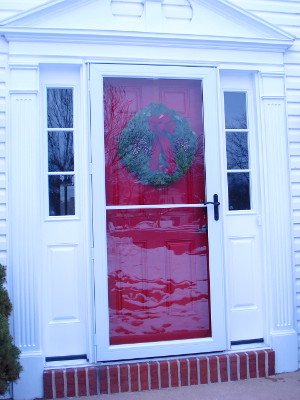Christmas wreath hung on door with magnets