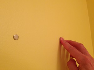 Attaching magnets to wall to hang a picture