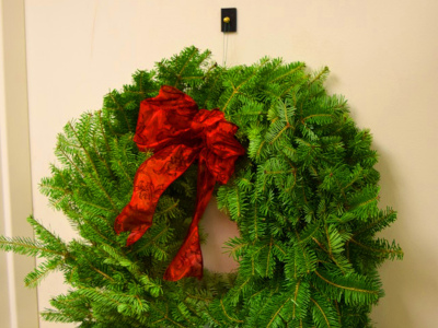 Rubber hook magnet hanging a christmas wreath on a metal door