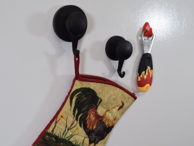 Hook magnet holding oven mitt on fridge for easy access