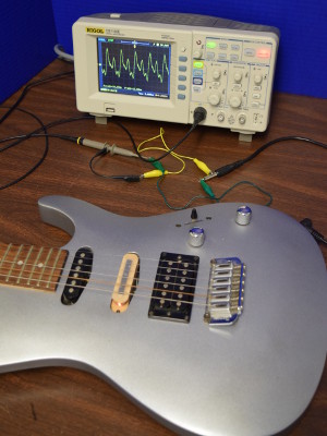 Guitar hooked up to oscilloscope