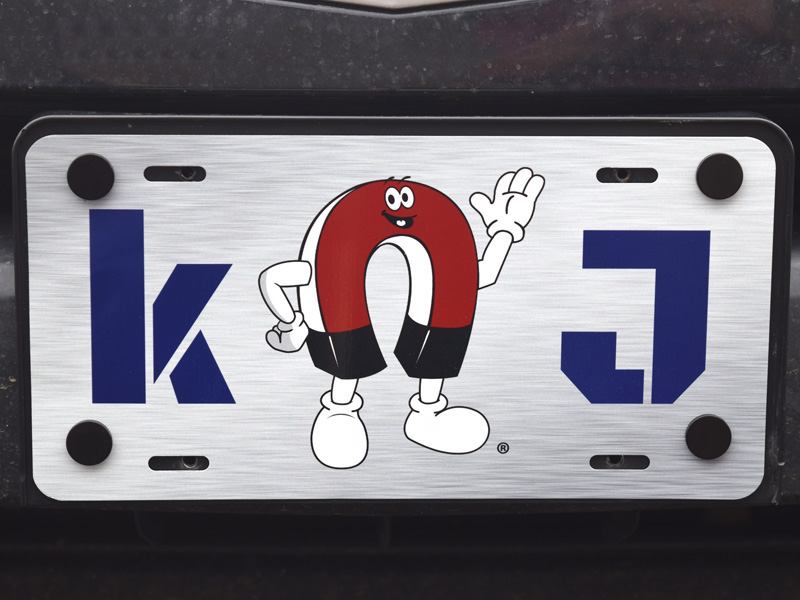 License plate attached to vehicle with plastic coated magnets