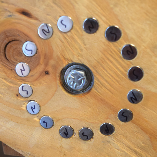 Magnets arranged in a cirle in wood