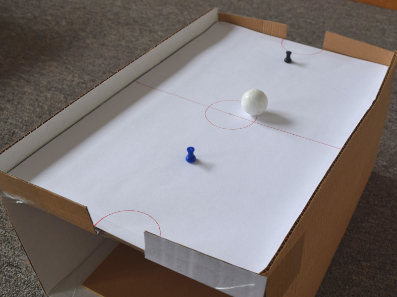 Using magnetic thumbtacks to move hockey ball
