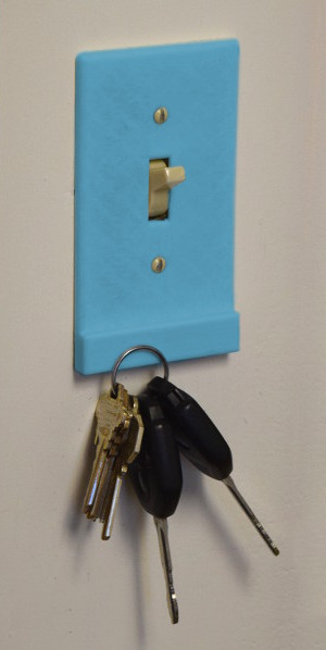 Keys hung on a light switch using magnets