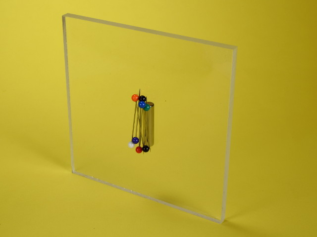 Magnet holding pins through glass