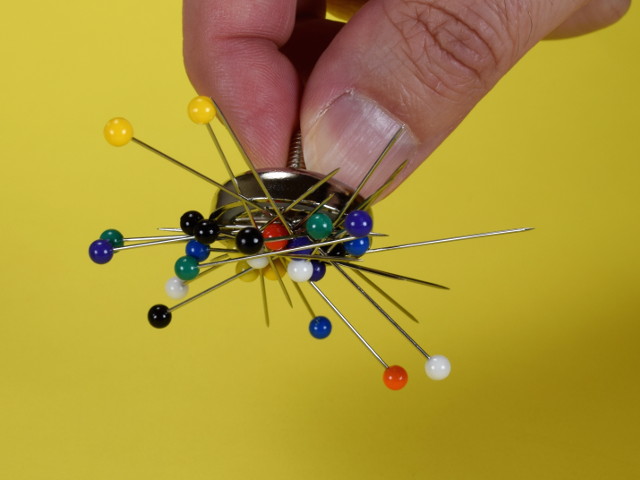 Pins stuck to magnet