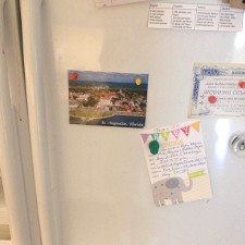 Magnets hanging many items on a fridge