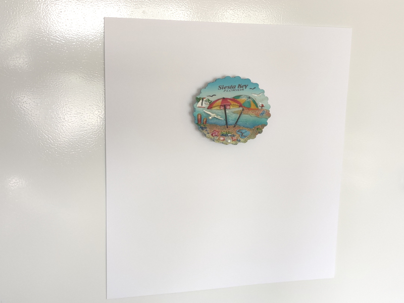 Shore magnet holding 10 pieces of paper on fridge