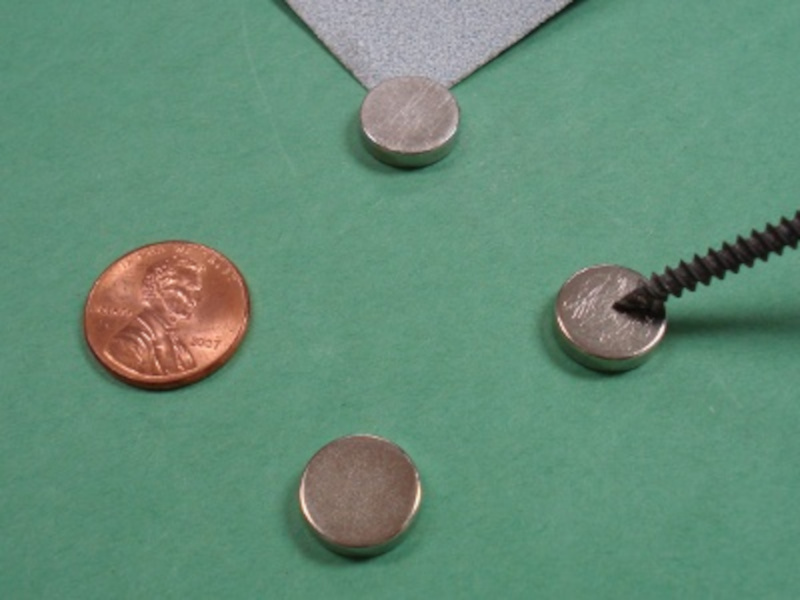 Scratching magnets with screw to improve glue bond