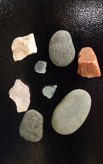 Rocks hanging on fridge with magnets