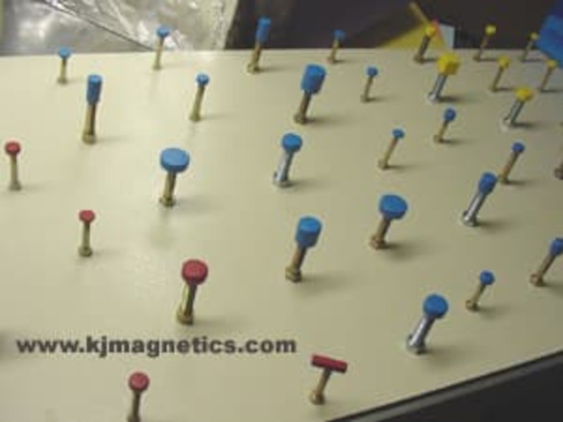 Magnets in various rubber coating colors drying