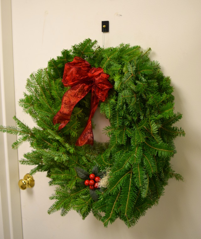 Christmas wreath hung on door with rubber mounting magnet