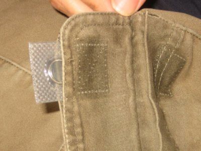 Sewing magnet being inserted into pants pocket