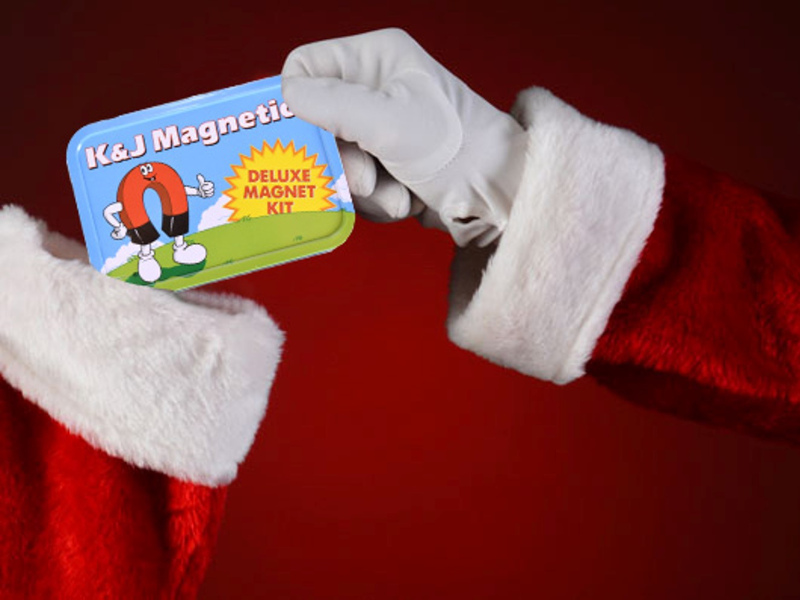 Santa dropping gift magnets into a christmas stocking